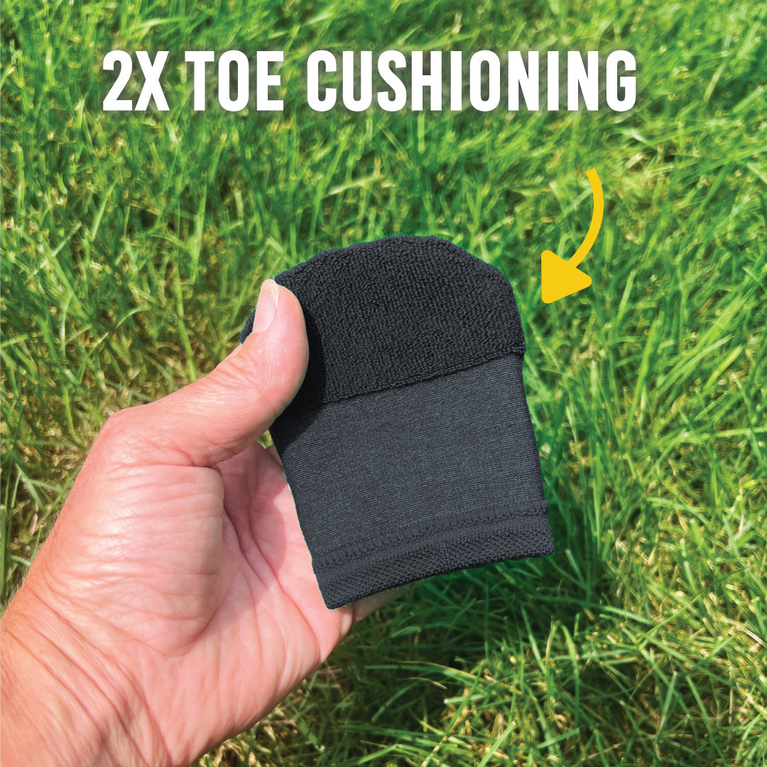 Black toe cover held in a hand with grass background and '2X Toe Cushioning' text.